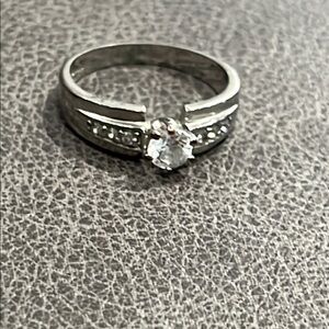 *Elegant Silver and White Solitaire Ring with Accent Stones